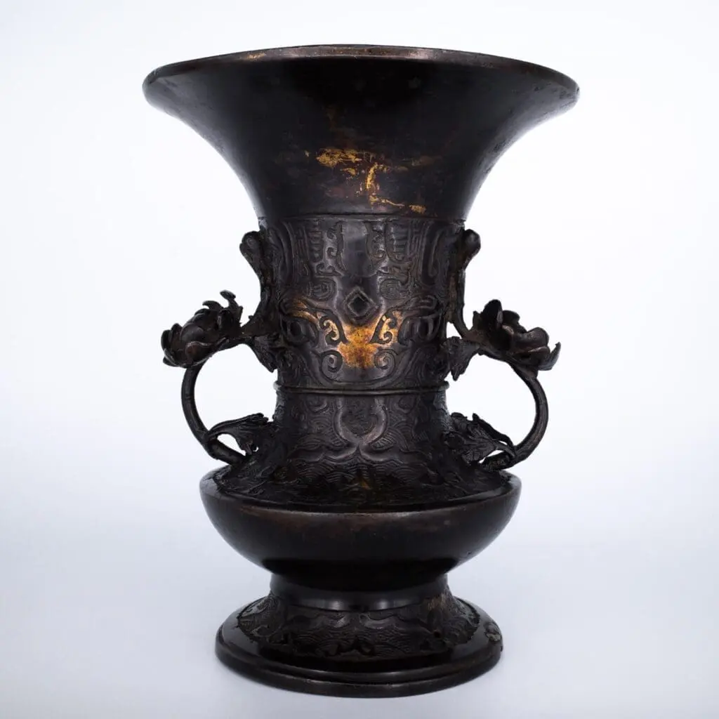 Antique Bronze Gu Form Altar Vase With Taotie Mask Decoration and Floral Handles. 19th century