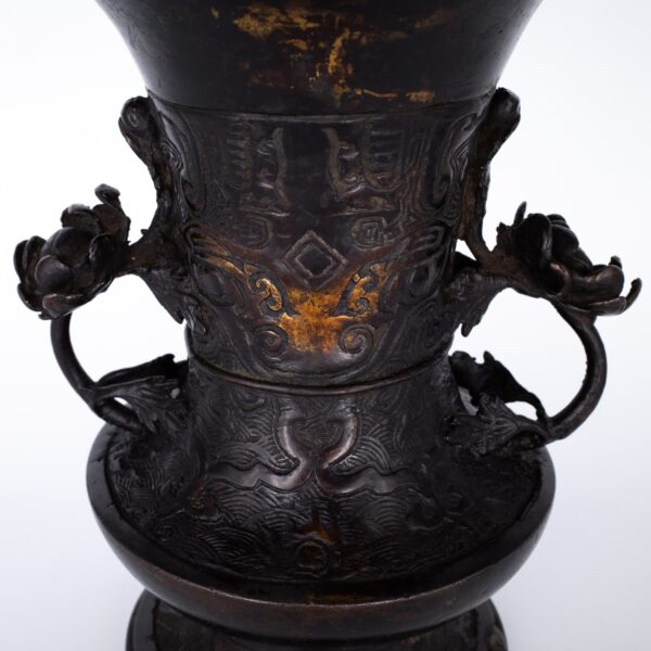 Antique Bronze Gu Form Altar Vase With Taotie Mask Decoration and Floral Handles. 19th century