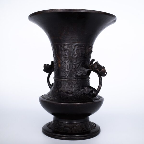 Antique Bronze Gu Form Altar Vase With Taotie Mask Decoration and Floral Handles. 19th century